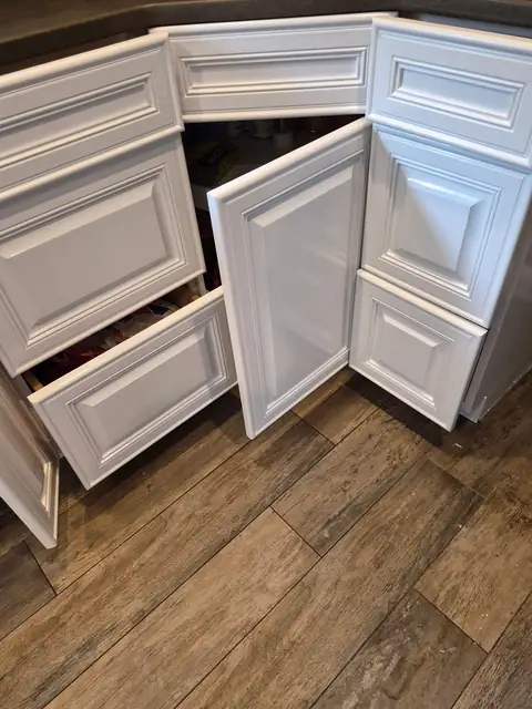 Corner base cabinets refinished in white