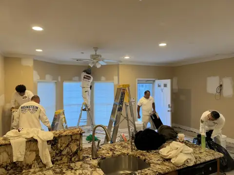 Walker Painting crew painting an open kitchen and living area
