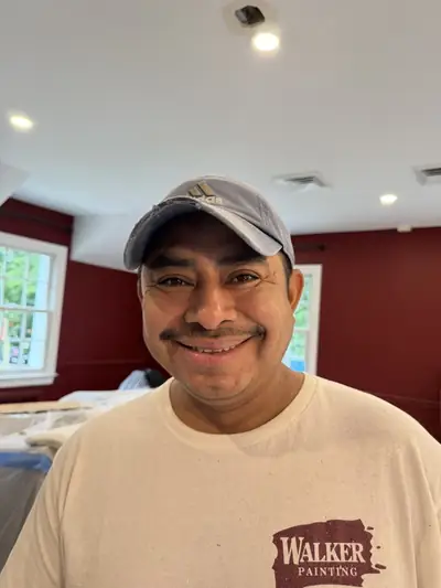 A smiling Walker Painting crew member on the job