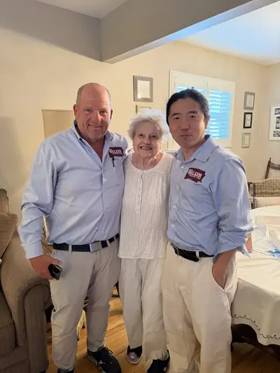 Walker Painting crew members with a longtime client at her home