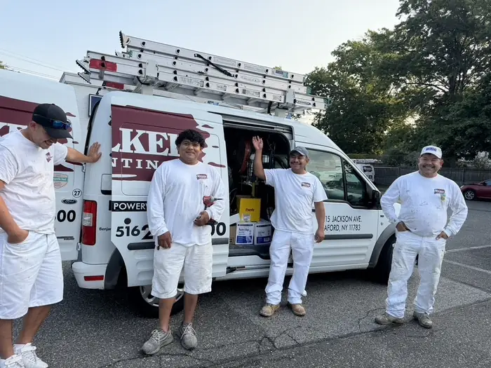 Walker Painting crew members beside the company van