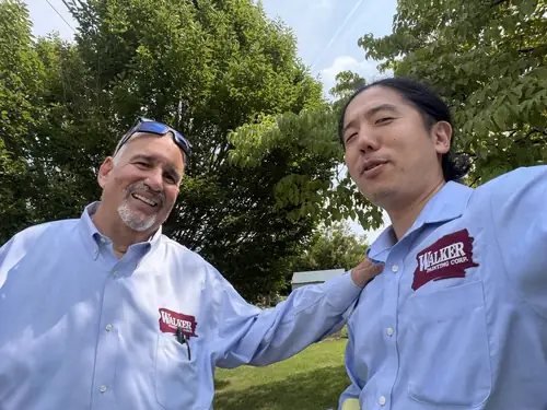 Walker Painting leadership sharing a laugh outside a Long Island home